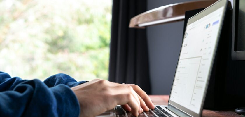 person using macbook pro on table