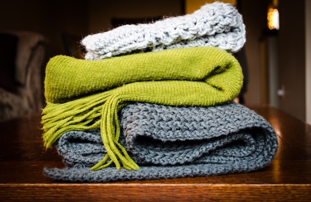 three-gray-green-and-white-scarf-on-top-of-table