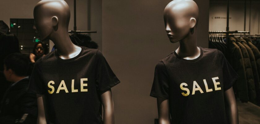 two mannequins with black Sale graphic crew-neck t-shirts